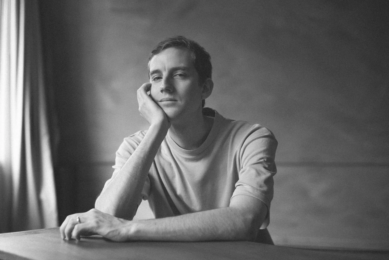 Sebastian Vinet seated in a black-and-white portrait